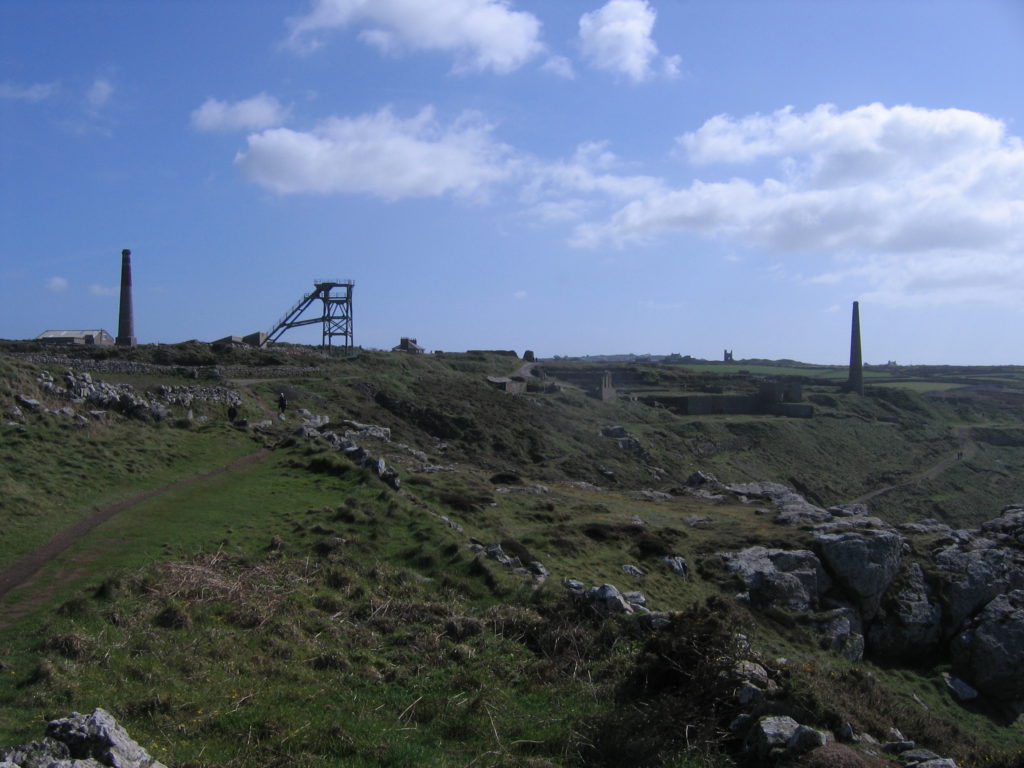 mining remains, chimneys and St Just church in the distance, Cornwall photo